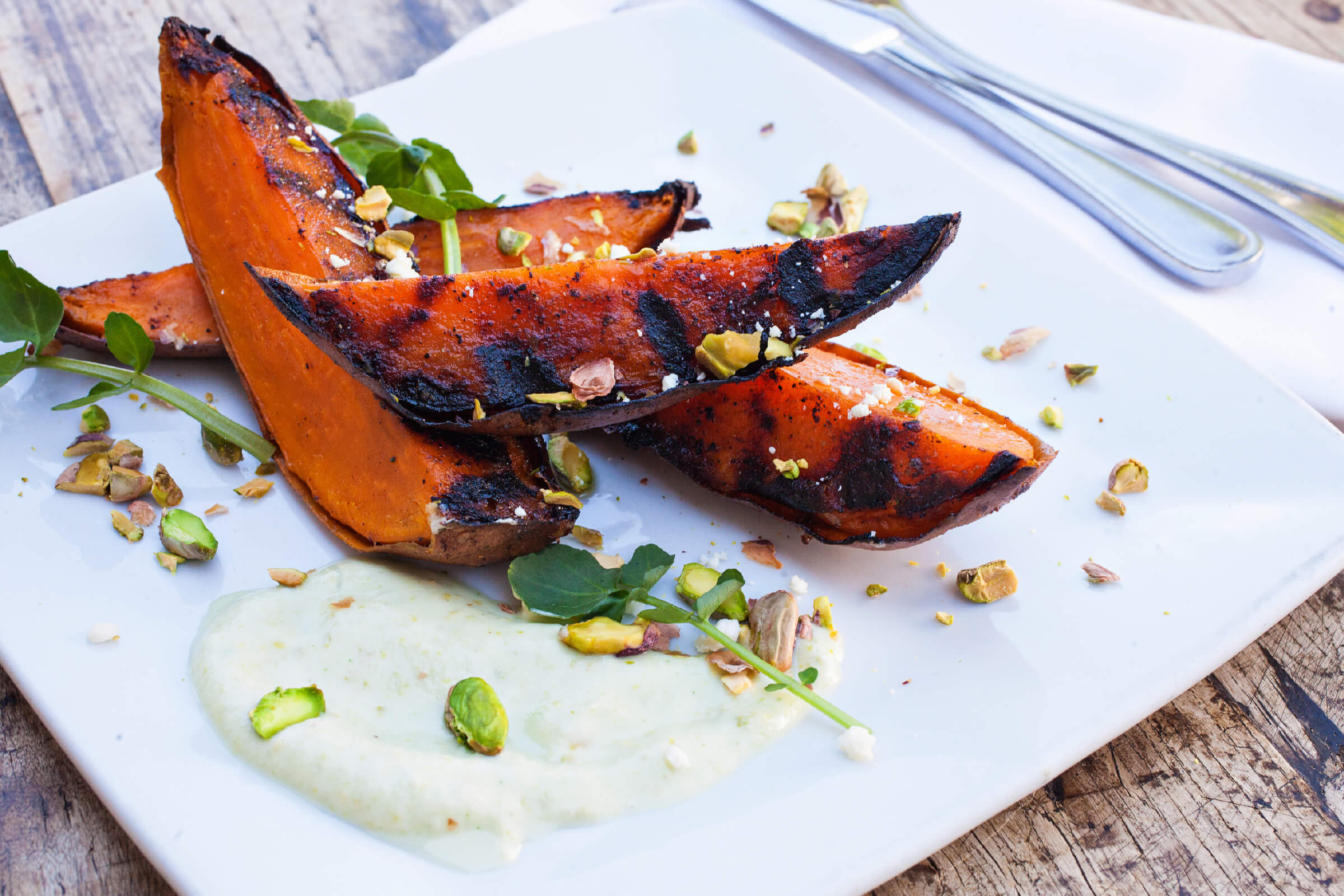 BBQ POTATOES WITH CANDIED SPICED PISTACHIOS, PISTACHIO CREMA & WATERCRESS