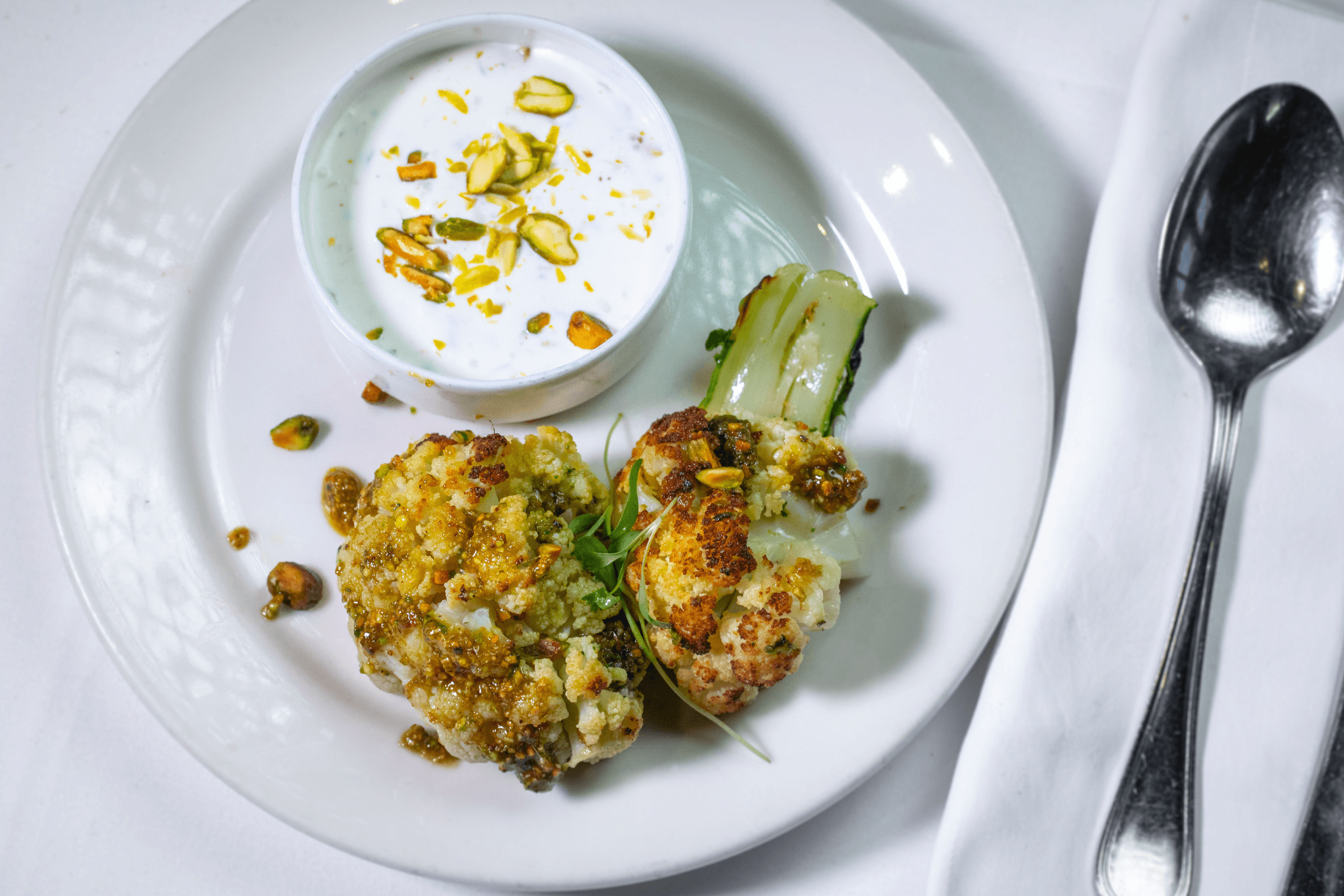 Whole Roasted Cauliflower with Pistachio Crumble and Green onion Cremè Fraiche